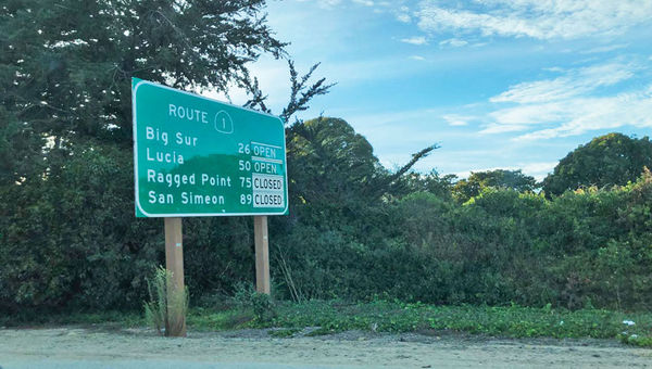 A sign alerts drivers to closed roads along Highway 1.