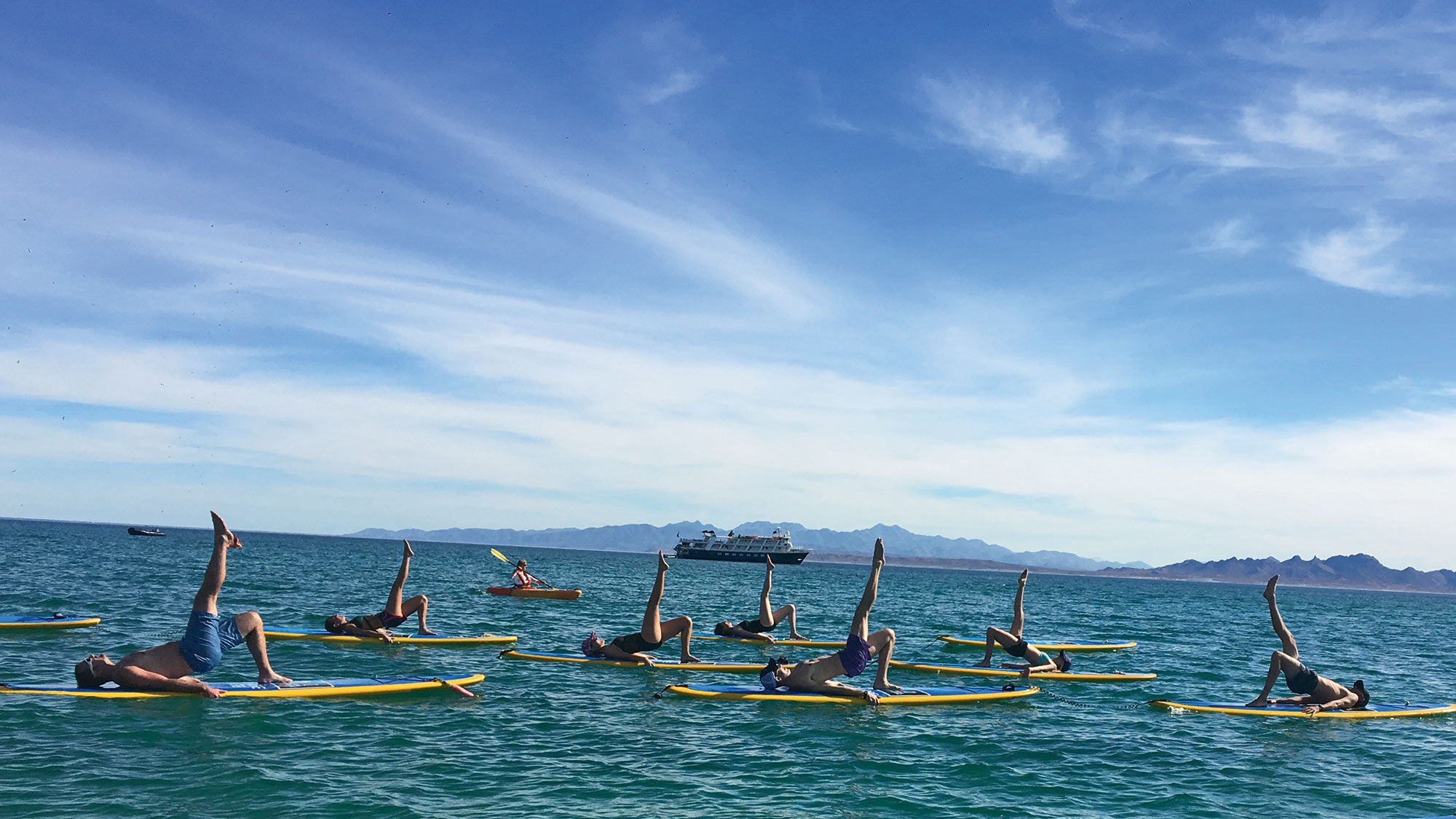 Stand-up paddleboard yoga, an activity on Lindblad's wellness cruise.