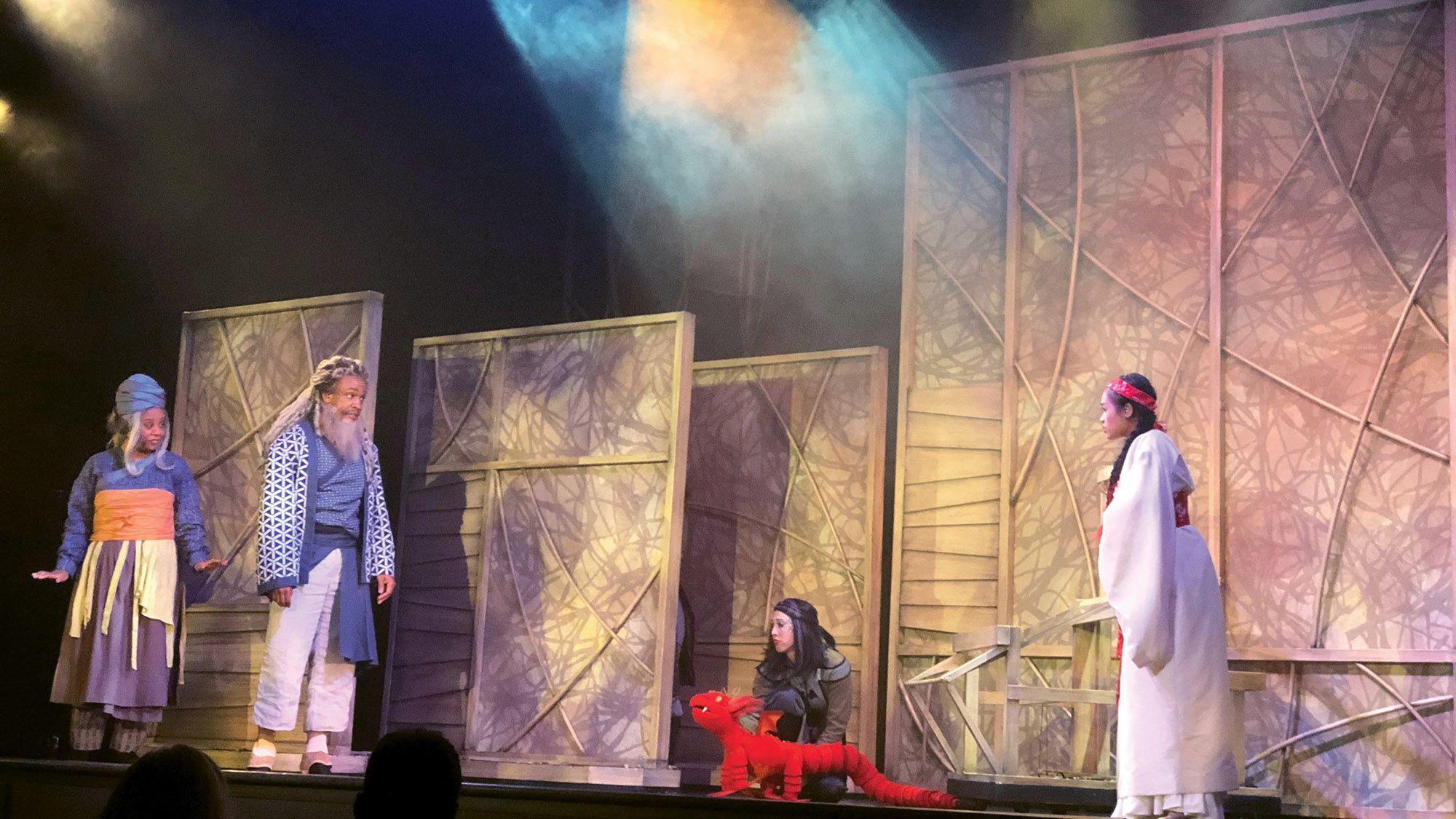 A red dragon is one of the puppets featured in the musical “The Secret Silk.”
