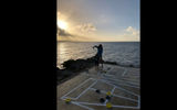 The shuffleboard court, overlooking the coastline, was a popular sunset activity.