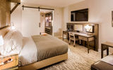 Guestrooms feature wooden ''canopies'' that envelope the bed and side-table areas. A luggage perch replaces the closet, while work desks are wide and relatively shallow.