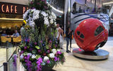 On this preview cruise, a tower of orchids and other live flowers stands next to the sculpture ''VW Beetle 1953'' on the Royal Promenade.