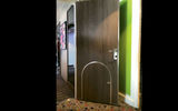 The standard sized door to the kids bedroom in the Ultimate Family Suite has a kid-sized door cut into it.