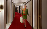 Carpeted in TWA's signature red, the curved hallway features walnut trim, walnut doors and terrazzo guest room entryways.