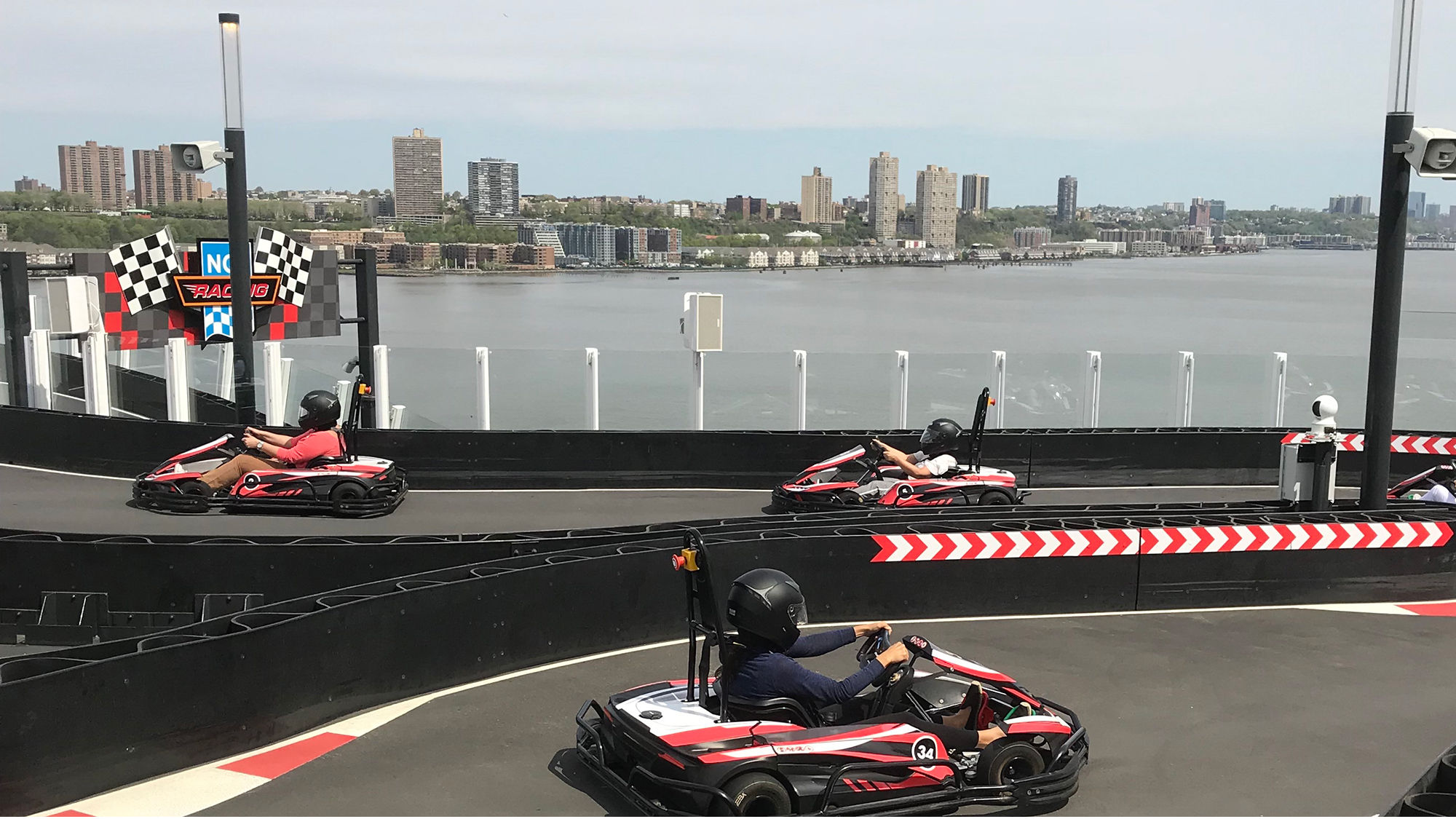 Travel Weekly's Johanna Jainchill (foreground) driving a go-kart on the Norwegian Bliss.