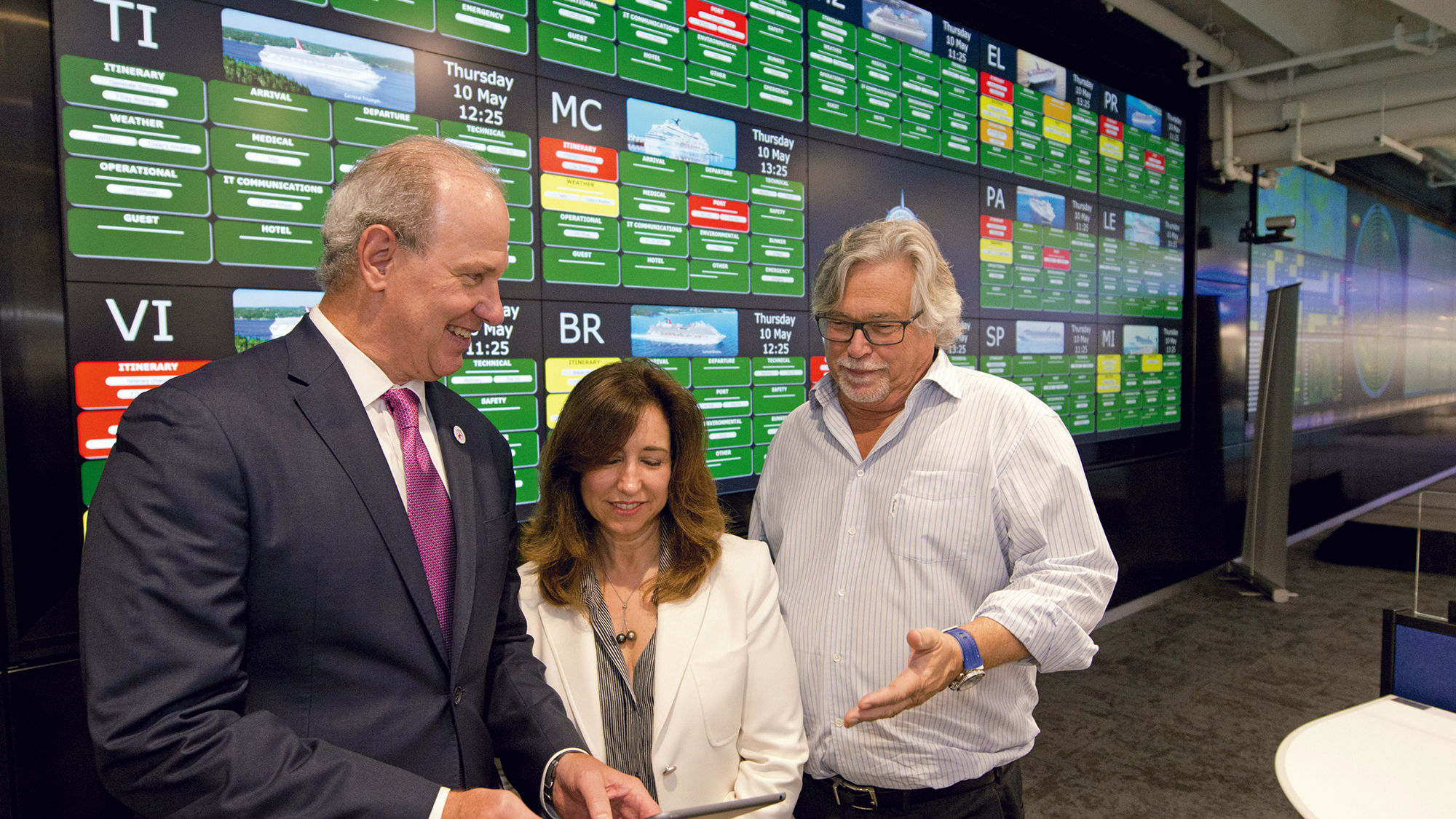 At the preview of Carnival Cruise Line's new Fleet Operations Center, from left, William Burke, chief maritime officer for Carnival Corp.; Christine Duffy, Carnival Cruise Line president; and Micky Arison, Carnival Corp. chairman.