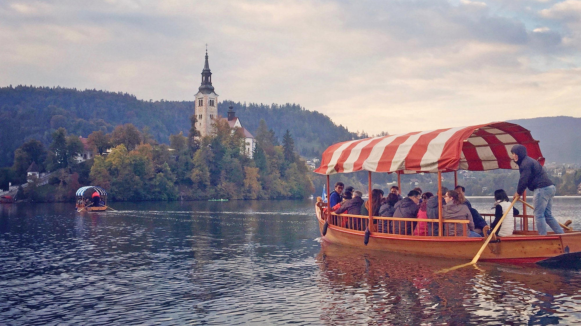 Traditional pletna boats ferry visitors to a tiny island on Lake Bled, where children can ring the church’s bell.
