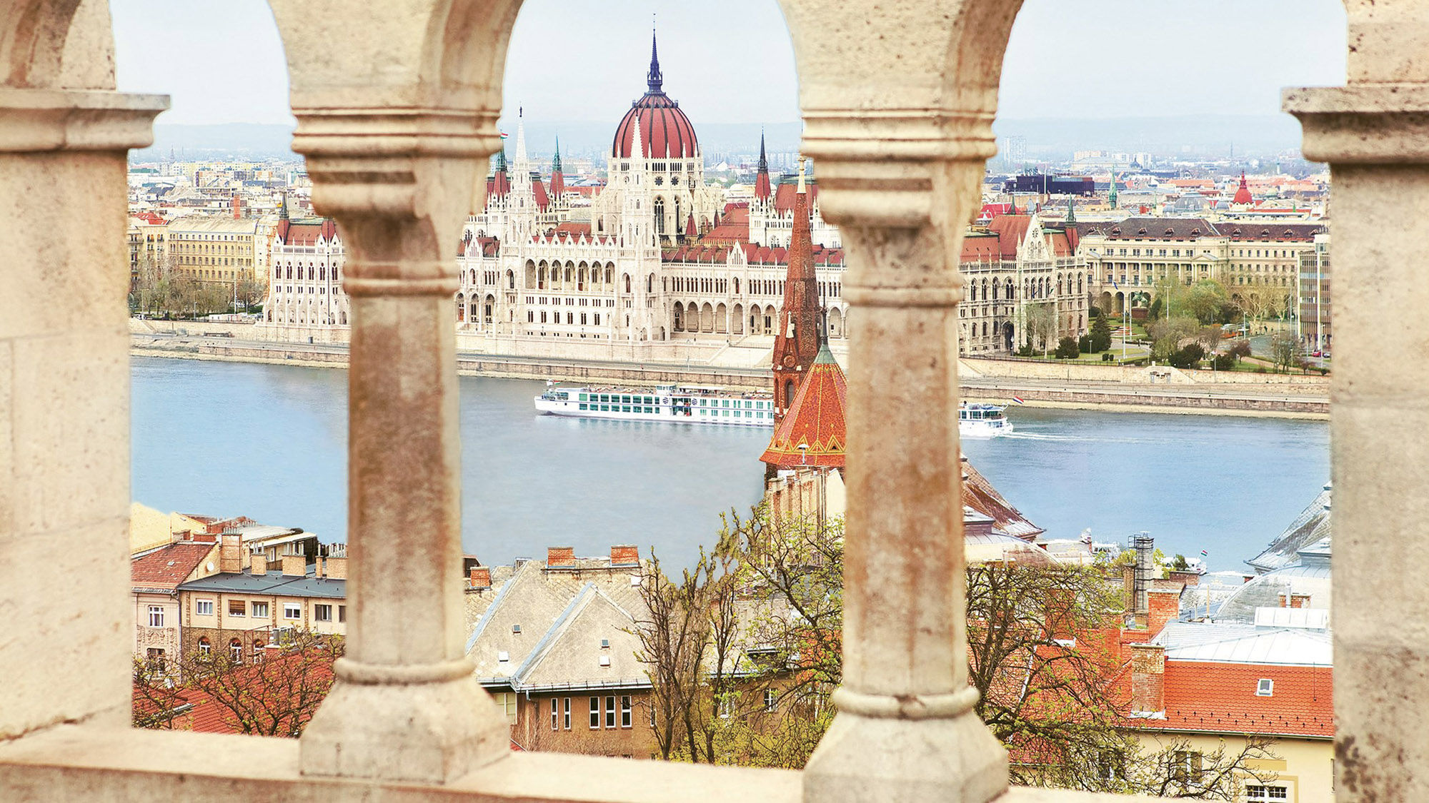 Uniworld’s Beatrice cruises past the Hungarian Parliament Building in Budapest, a highlight of Lower Danube cruises.