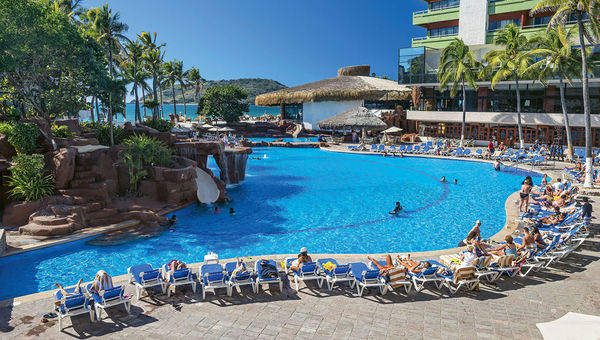 The pool features waterfalls, cove-like rock formations and a swim-up bar.