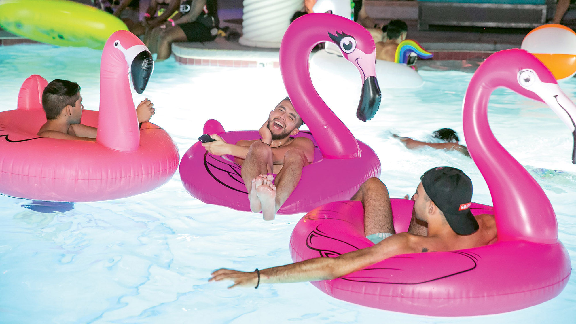 Revelers float along during Electric Safari, an LGBTQ pool party at the Flamingo.