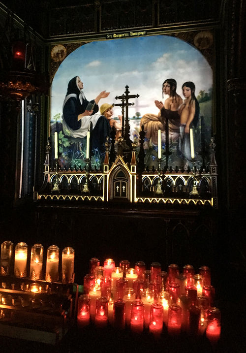 Light highlights the gold on devotional art at Notre-Dame Basilica in Montreal during the first part of the "Aura" experience.