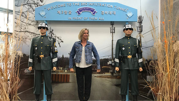 The author posing with the life-size cut-outs of soldiers at the 3rd infiltration tunnel.