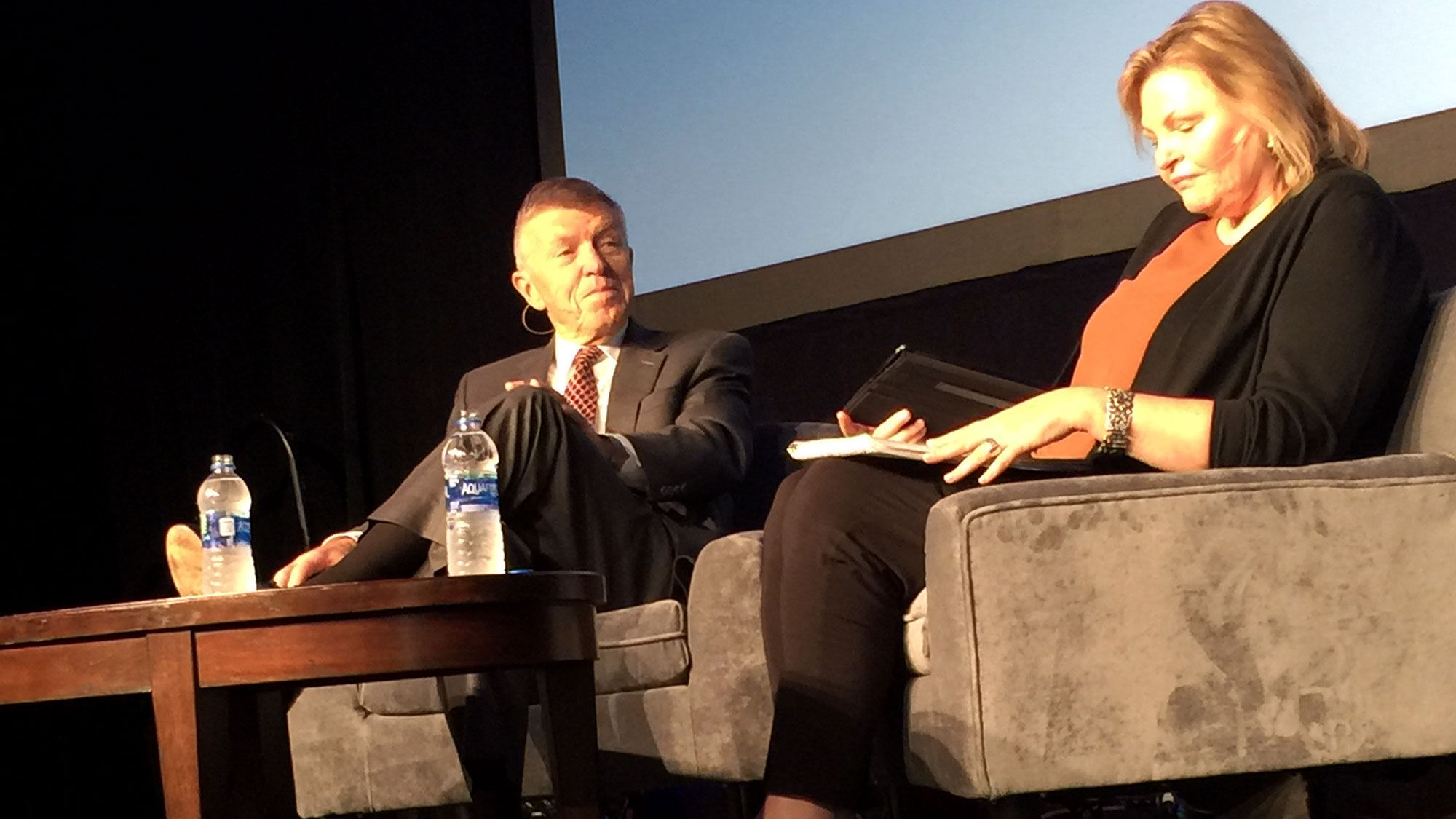 "I think we'd be better off with some modicum of regulations that moderate the behavior of the industry," Bob Crandall said. At right is interviewer Holly Hegeman, publisher of the newsletter PlaneBusiness Banter.