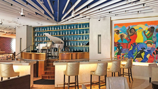 The Grand Hyatt Baha Mar’s West lobby is anchored by a small bar area, colorful art pieces and an elevated grand piano.