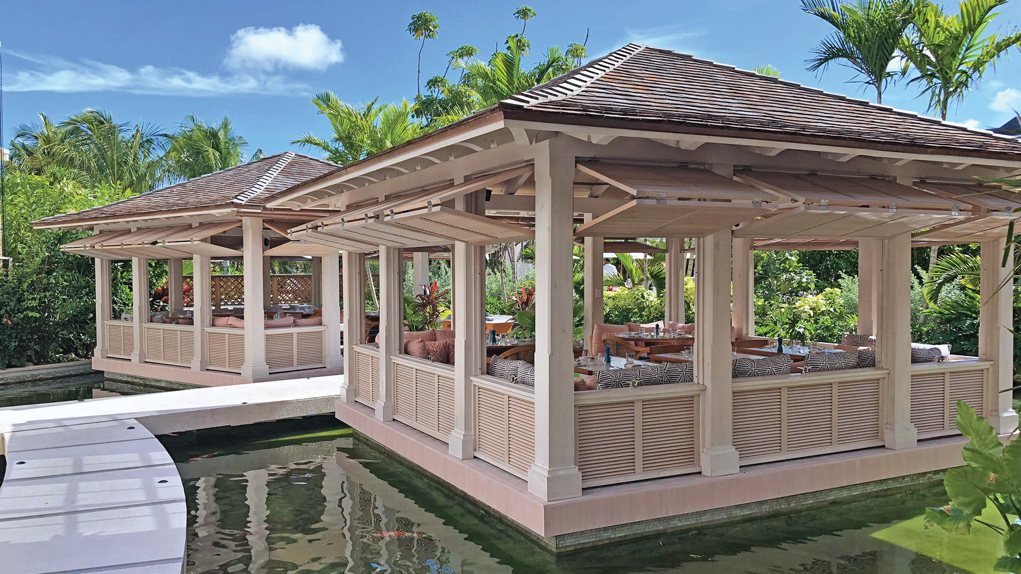 The Rosewood’s Costa restaurant features cozy seating areas in open-air huts over a koi pond.