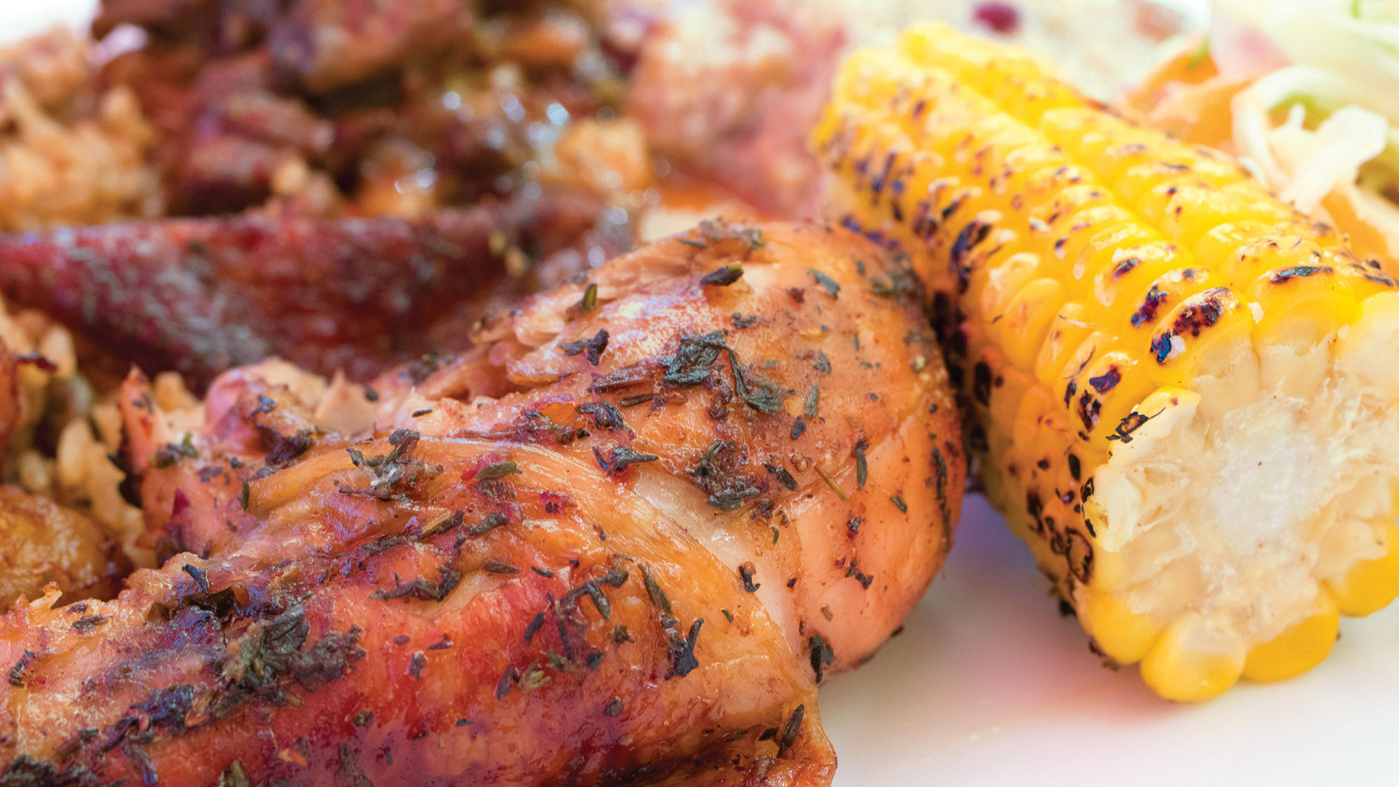 Jerk chicken with roast corn and other sides at Crackpot Kitchen.