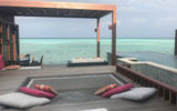 Overwater villa with private infinity pool at Four Seasons Resort Maldives Kuda Huraa.