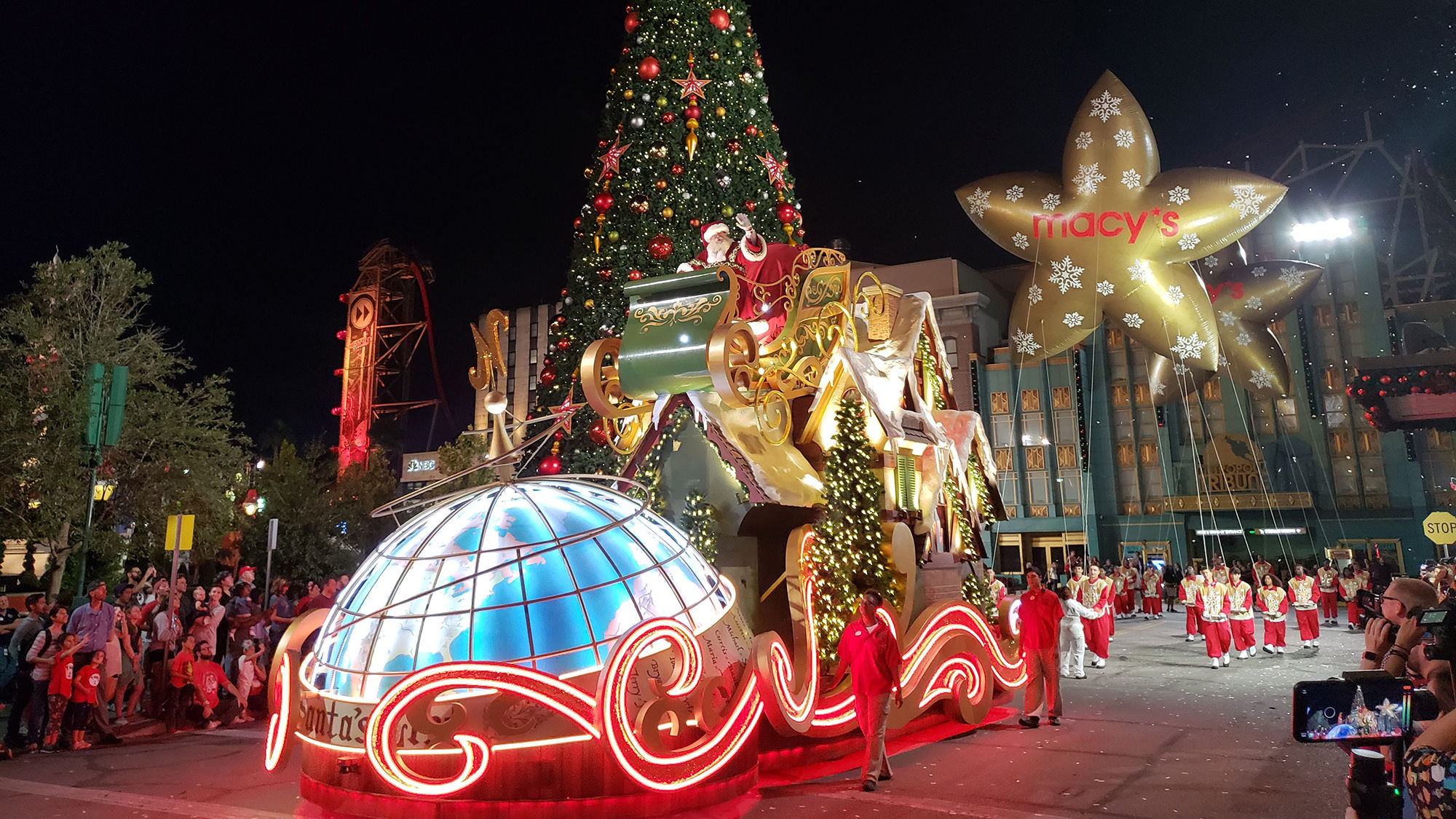 Santa waves to the crowd at Universal's Holiday Parade featuring Macy's at Universal Studios Florida.