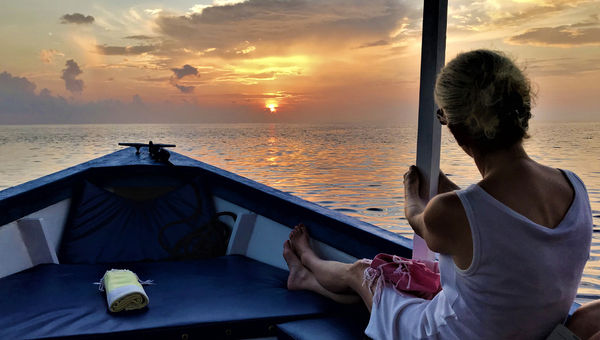 A guest at Bawah Reserve takes in the view on the Six Island Sunset Cruise. A guest at Bawah Reserve takes in the view on the Six Island Sunset Cruise.