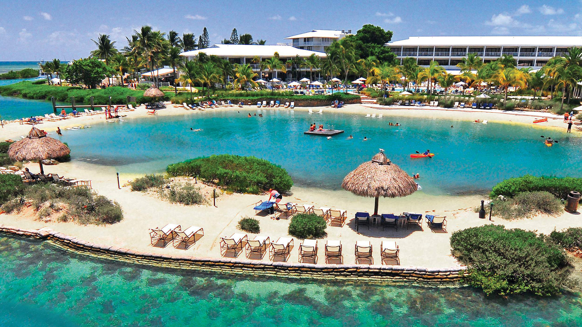 Hawks Cay's saltwater lagoon, lined with thatch-roof tikis, abuts Florida Bay, leading to the Atlantic.