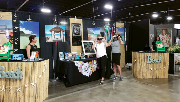 Guests viewing content from Virtual Honeymoon at a bridal show. Guests viewing content from Virtual Honeymoon at a bridal show.