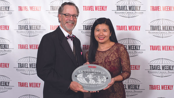 Steve Diggelmann and Jennie Ho of Delta Vacations, which won the tour operators Packaged Overall category and for its travel agent educational program.
