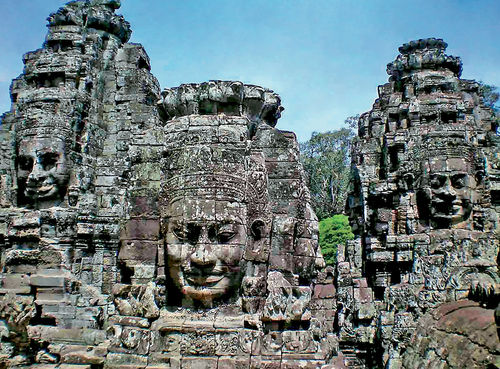 Ancient faces look on across time at Angkor Thom in Cambodia. Ancient faces look on across time at Angkor Thom in Cambodia.