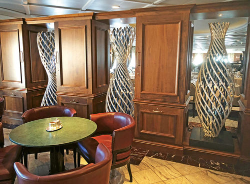 The bookcase that once separated the main dining room from a bar/waiting area has been replaced by 6-foot abstract metal sculptures. The bookcase that once separated the main dining room from a bar/waiting area has been replaced by 6-foot abstract metal sculptures.