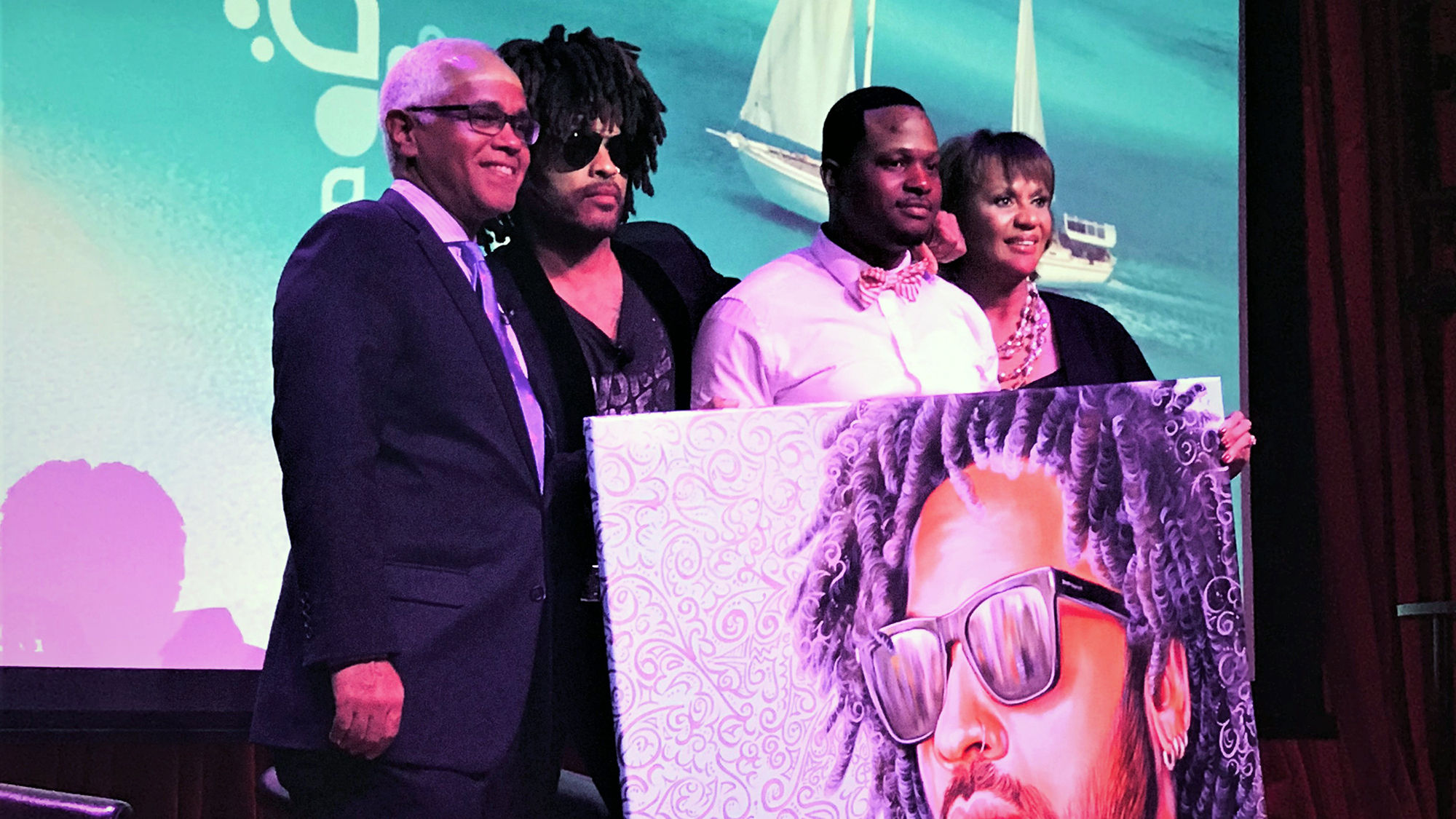 From left: Bahamas minister of tourism and aviation Dionisio D’Aguilar; singer Lenny Kravitz; Bahamian artist Jamaal Rolle, with his painting of Kravitz; and the ministry’s director general, Joy Jibrilu.