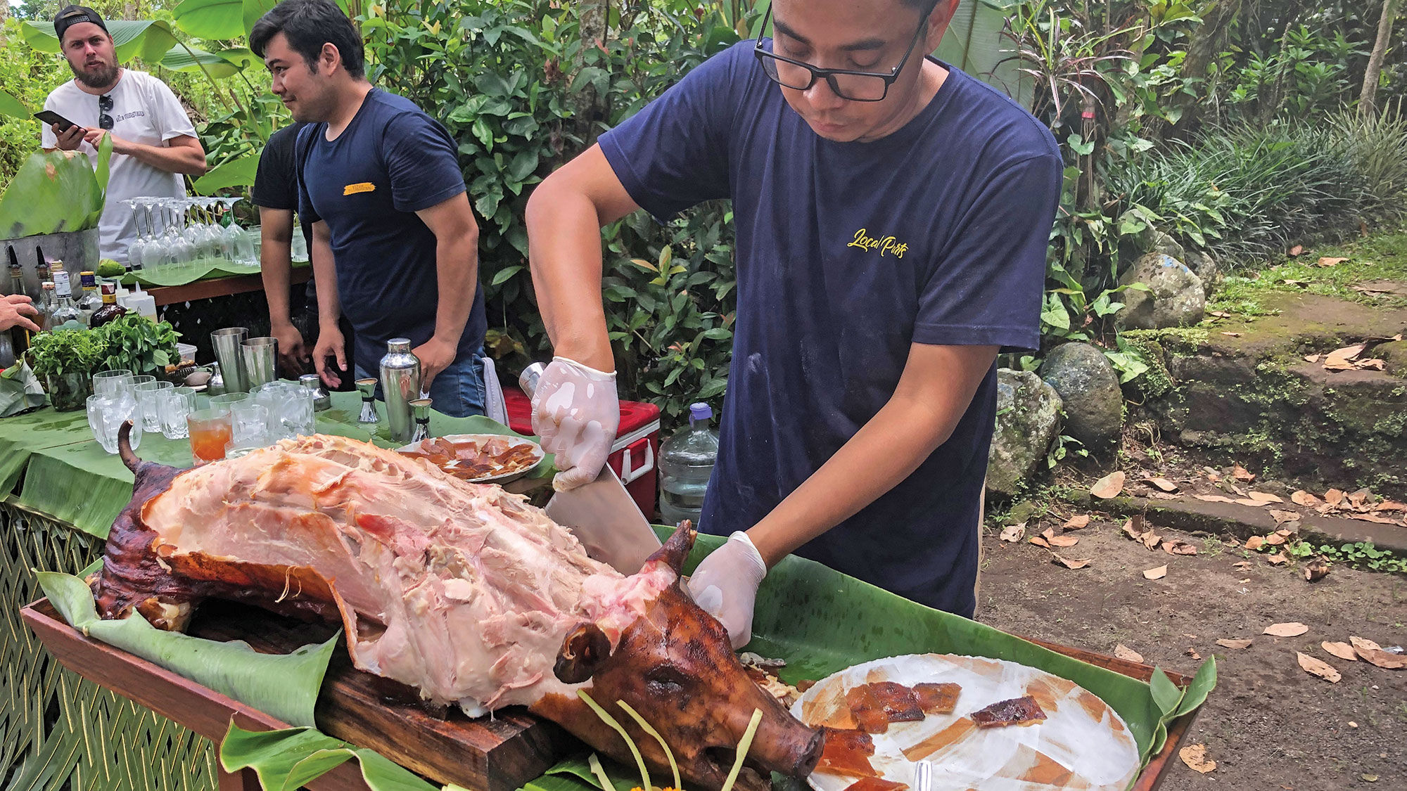 A roast suckling pig is carved in Bali and served to guests on a Silversea expedition.