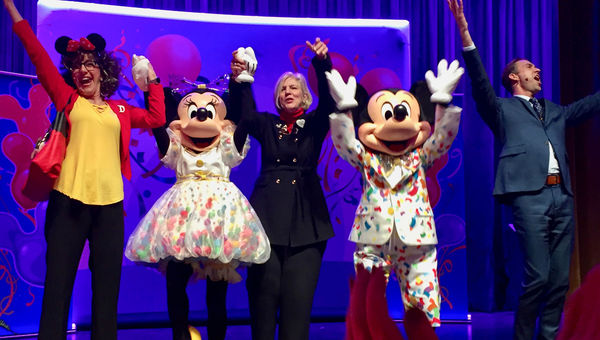 Disney executive Claire Bilby (center) was joined on stage at the Discover the Magic Tour 2019 by Mickey and Minnie Mouse as well as event emcees Sharon Tipps and Shawn Matthews. Disney executive Claire Bilby (center) was joined on stage at the Discover the Magic Tour 2019 by Mickey and Minnie Mouse as well as event emcees Sharon Tipps and Shawn Matthews.