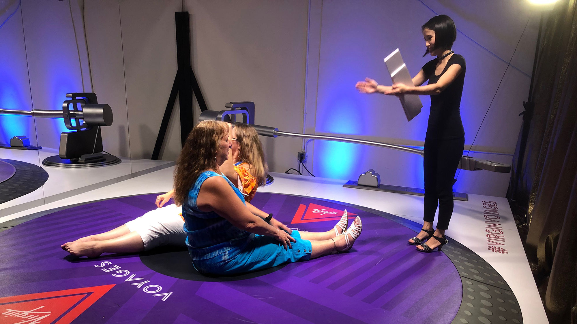 Travel advisors attending Cruise360 posed on a giant turntable at the Virgin Voyages Warehouse54 event.