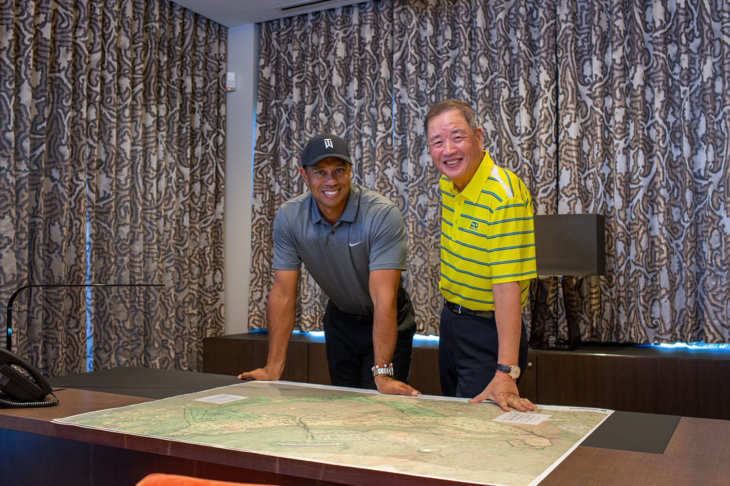 Tiger Woods with Du Sha, owner and founder of Pacific Links International, which announced a partnership with Wood's design firm for a course on Oahu.