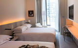 The property's guestrooms feature a sleek, minimalist aesthetic.