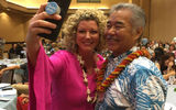 Jenn Lee, vice president of Travel Planners International, grabs a selfie with Hawaii Gov. David Ige. Both were speakers at the 2019 Travel Weekly Hawaii Leadership Forum.