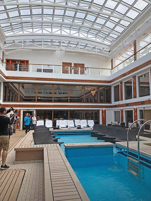 The pool and atrium in the Haven on the Norwegian Joy is covered by a retractable roof. The pool and atrium in the Haven on the Norwegian Joy is covered by a retractable roof.