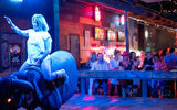 Christen Perry of Classic Travel Connection and a GTM advisory board member, rides the mechanical bull at Stoney's during GTM West's reception.