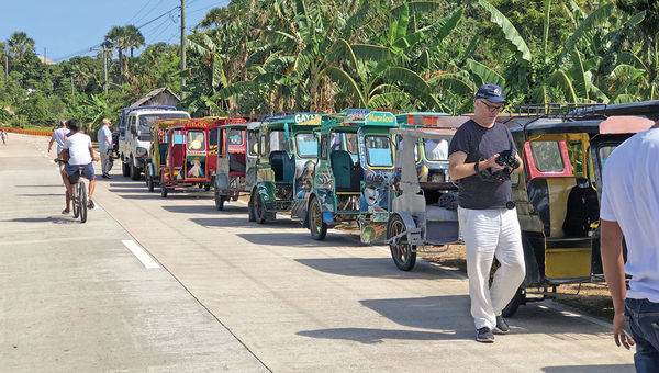 A caravan of “tricycles” along a road in Romblon. A caravan of “tricycles” along a road in Romblon.
