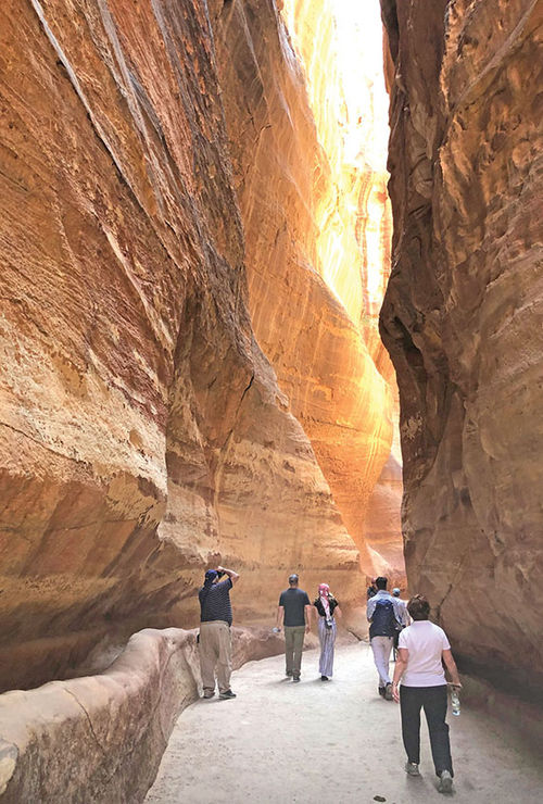 Visitors make their way through the Siq, a slot canyon that leads to the ancient city of Petra. Visitors make their way through the Siq, a slot canyon that leads to the ancient city of Petra.