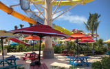 Umbrella-shaded picnic tables in the Thrill Waterpark.
