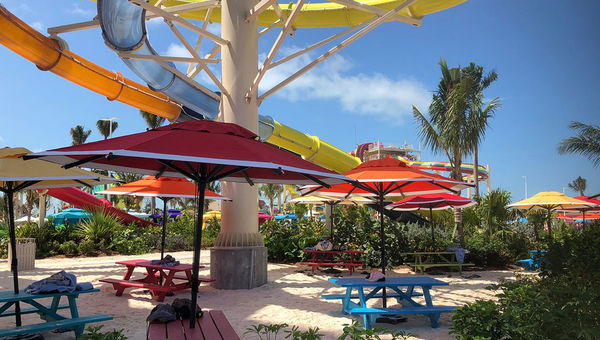 Umbrella-shaded picnic tables in the Thrill Waterpark. Umbrella-shaded picnic tables in the Thrill Waterpark.