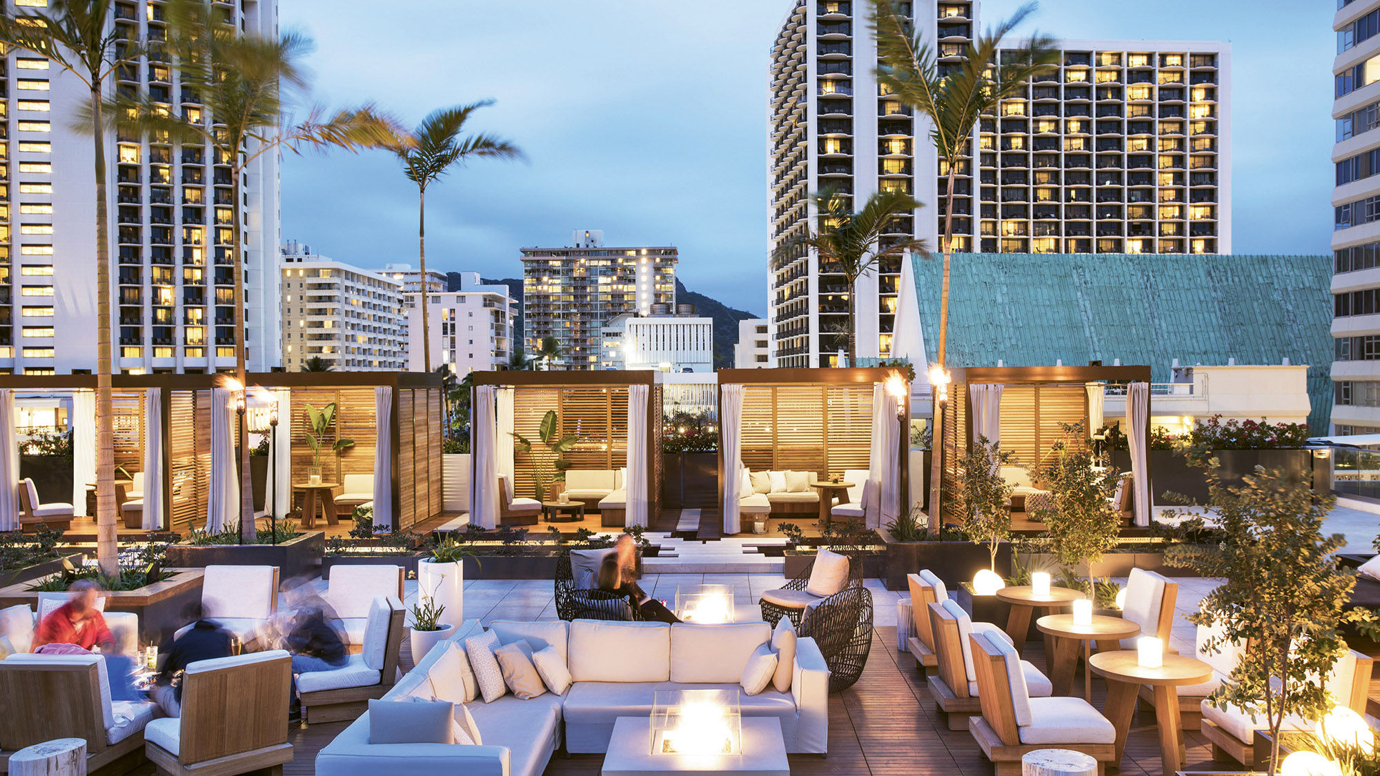 The pool deck at the Alohilani Resort Waikiki Beach features a saltwater infinity pool, cabanas and fire pits.