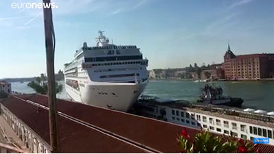 Video still of the MSC Opera running into a docked Uniworld river ship.