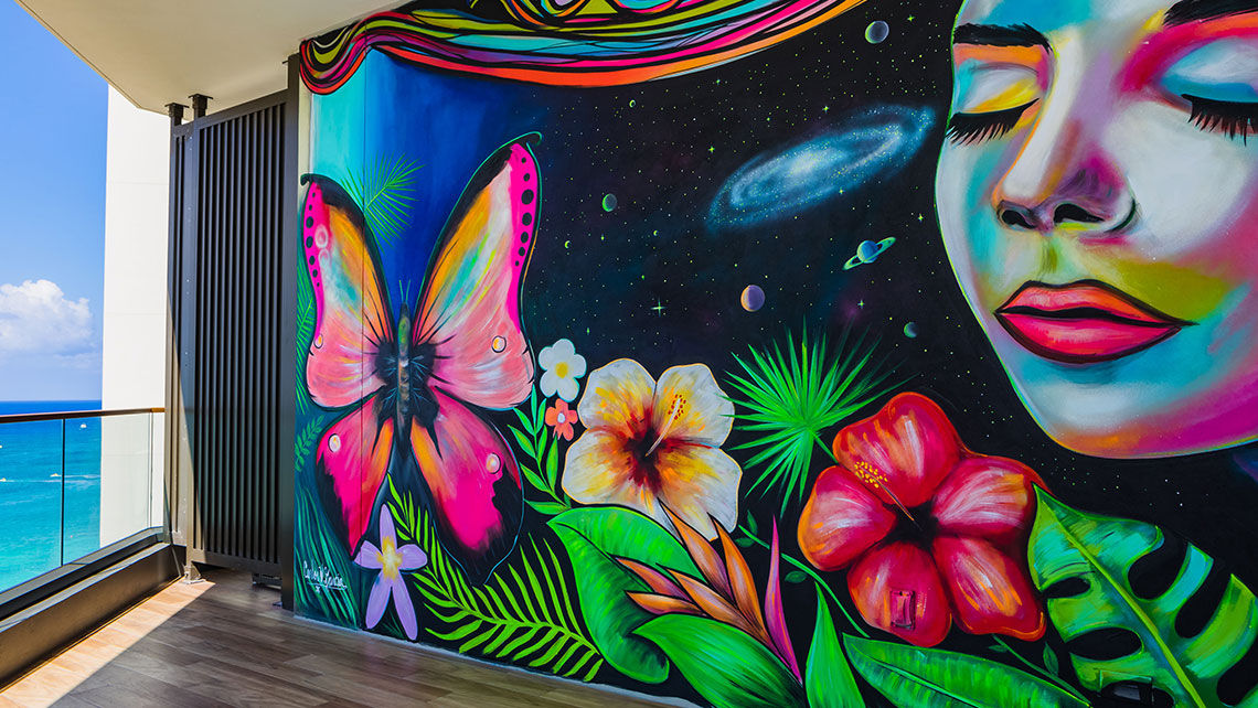 The balcony wall mural by local artist Carlos Garcia is a popular Instagram photo at Kimpton Seafire’s room 808.