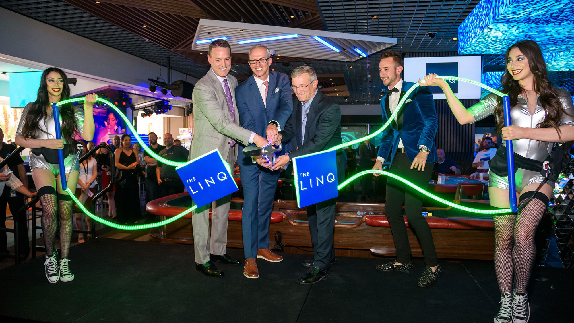 From left, company officials Ryan Hammer, Christian Stuart and Tony Rodeo cut the LED ribbon to one of the Linq Hotel + Experience's new immersive gaming environment during a ceremony on June 7,.