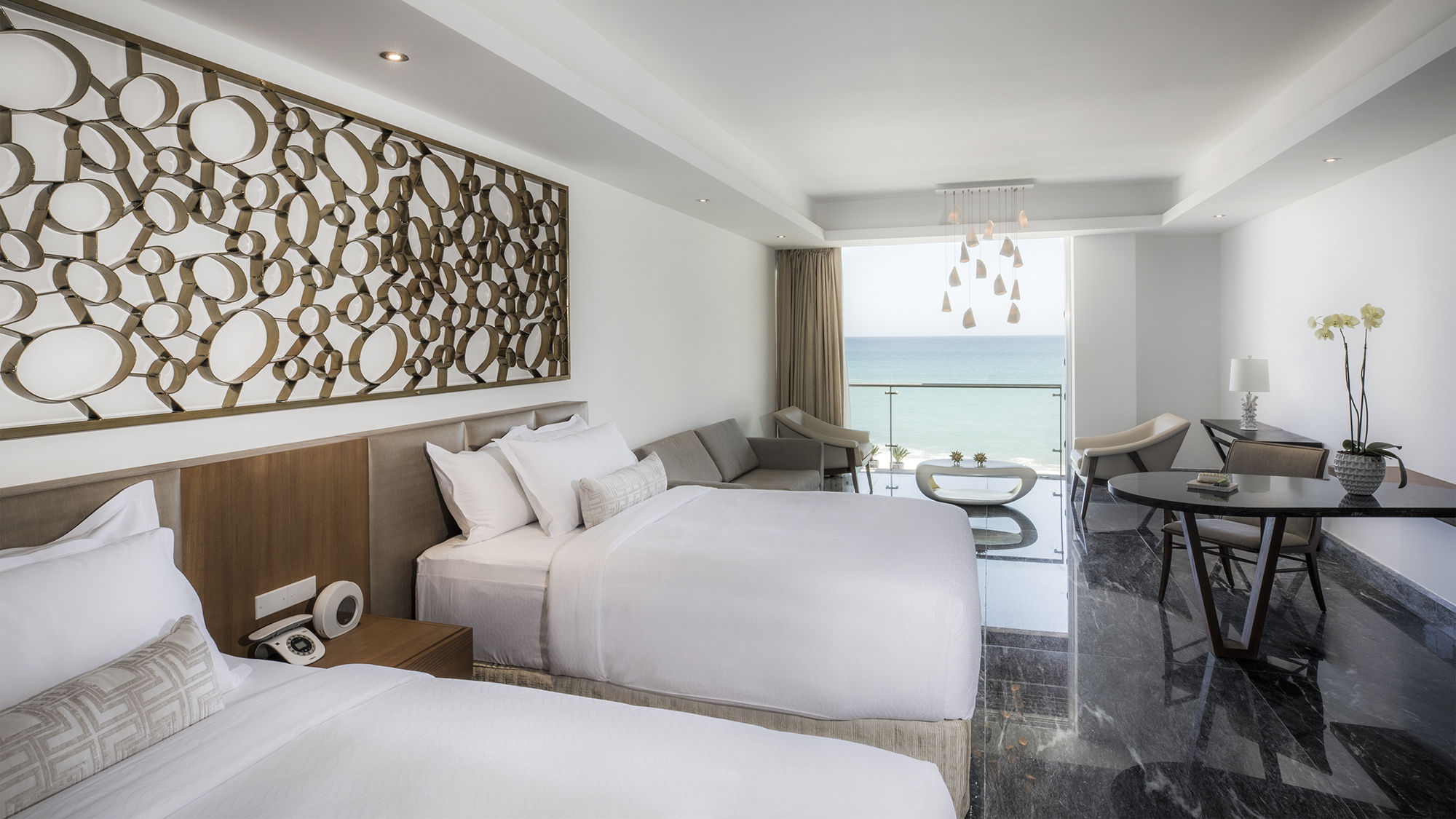 Two of the residence's four oceanfront bedrooms feature two double beds.