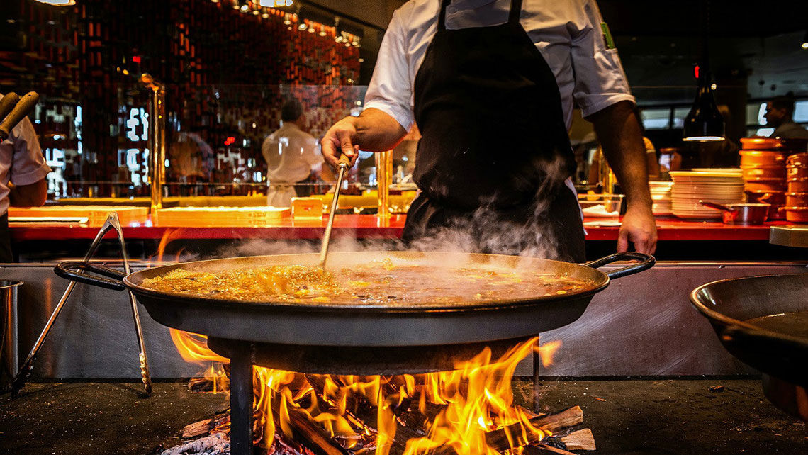 A chef stirs the paella at Jaleo by Jose Andres at Disney Springs. The restaurant is participating in Visit Orlando's Magical Dining event for the first time this year.