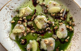 The scallop carpaccio appetizer at Showfish, with huckleberry argo dolce, spiced cashew and meyer lemon.