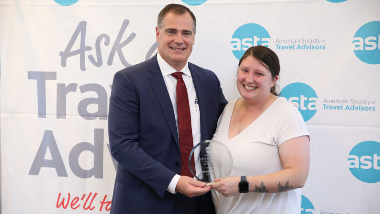 Travel Weekly senior editor Jamie Biesiada received the 2019 ASTA Journalist of the Year Award from the Society's CEO, Zane Kerby.