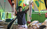 A fishmonger in Bourda market shows off the catch of the day.